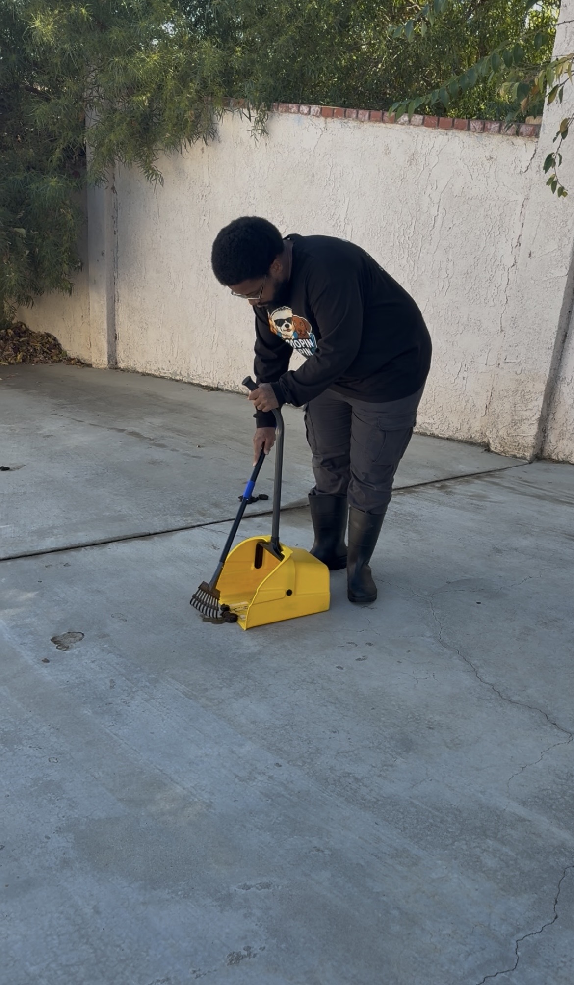 McScoopin Poopin owner working in Lancaster CA yard